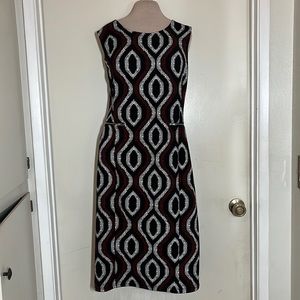 Black and red patterned sheath dress. Zipper details.